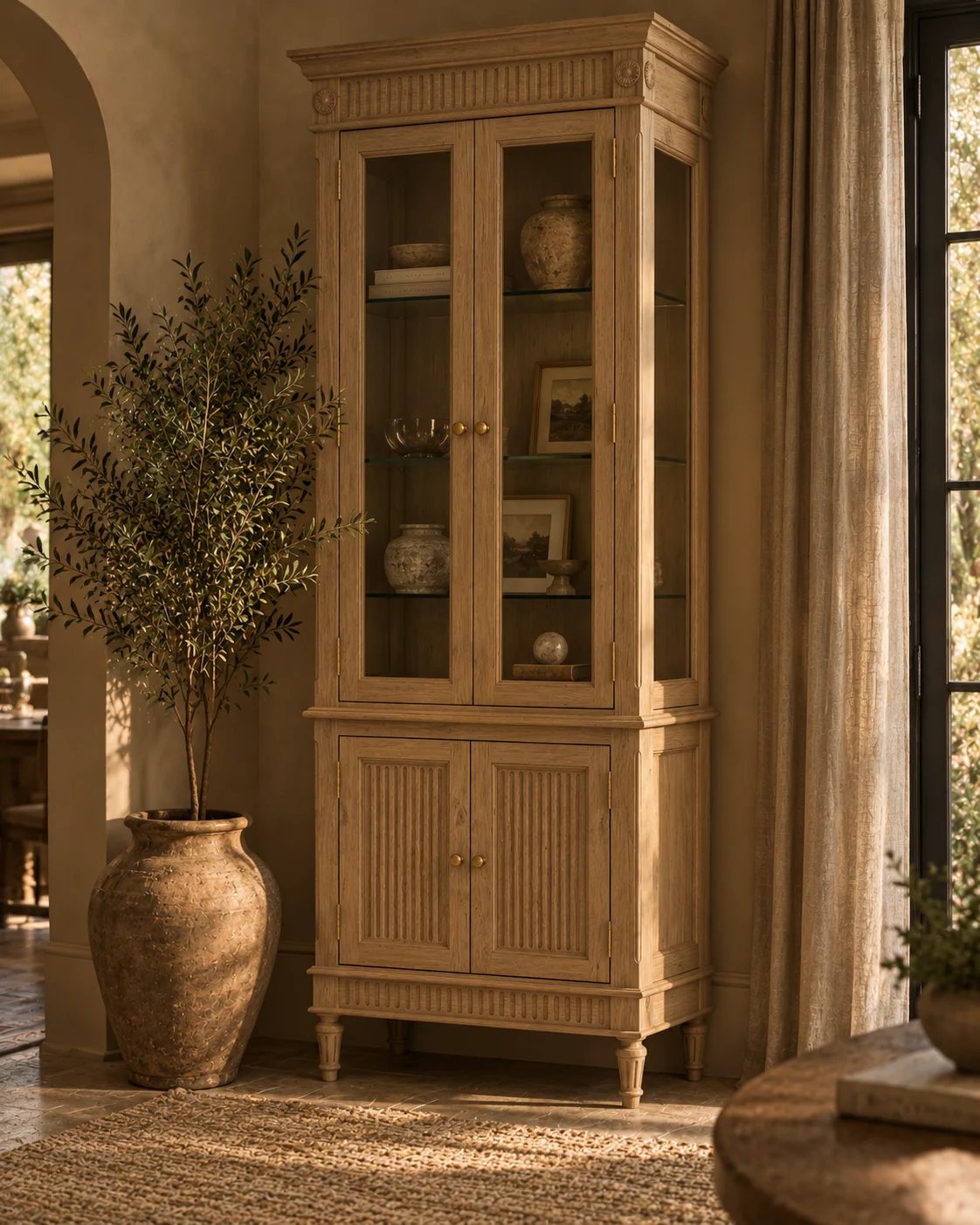 A cabinet with woven door panels and brass pulls in a softly lit room