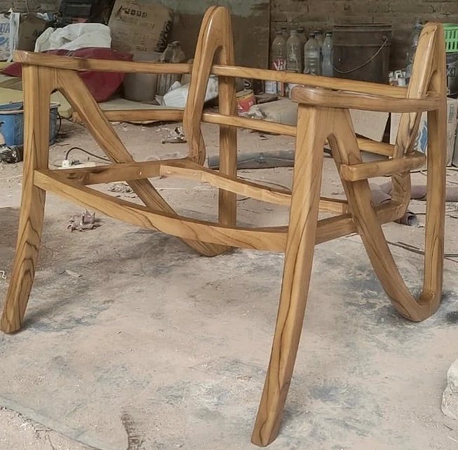 The unfinished wooden frame of Stenah's first chair in the workshop